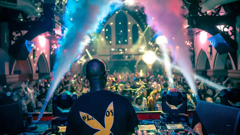 An action photo from one of the past Church Nightclub events taking place in the main room and featuring a crowd facing a DJ.